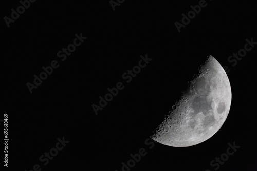 Obraz na płótnie crescent moon photographed with a telescope. The moon is at 50% luminosity w salonie