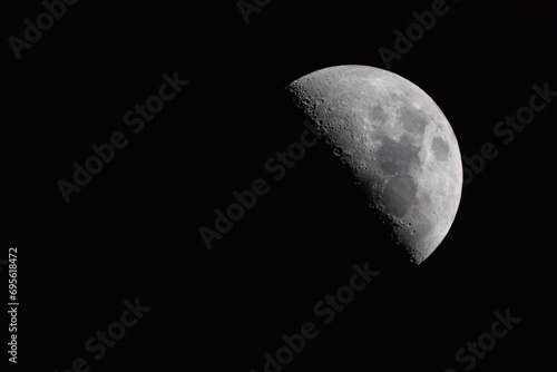 crescent moon photographed with a telescope. The moon is at 50% luminosity