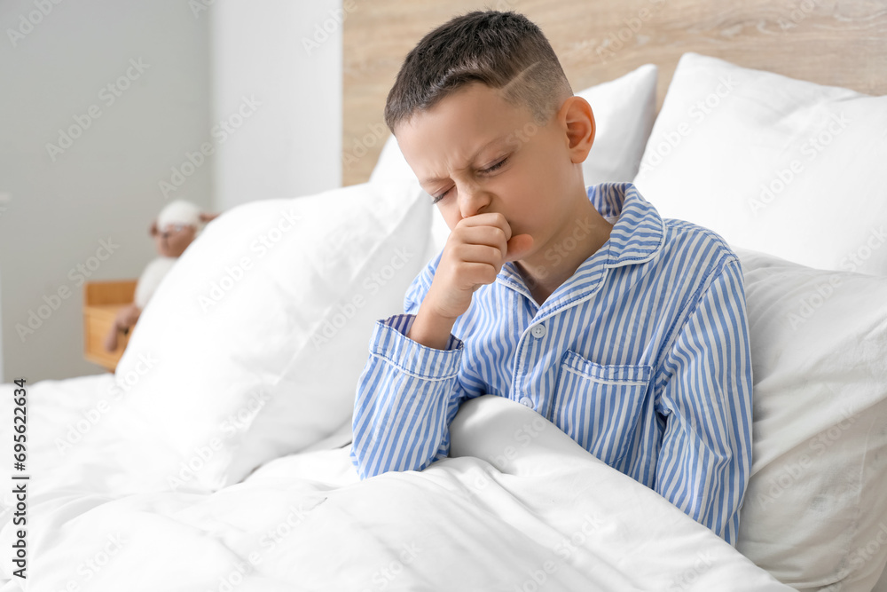 Ill little boy coughing in bedroom Ill little boy coughing in bedroom