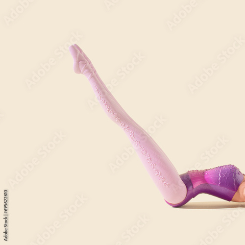 Girl legs on sandy color background. Minimal surreal, creative concept of ballet, Pilates, fitness workout and healthy lifestyle. Frontal view. Copy space.