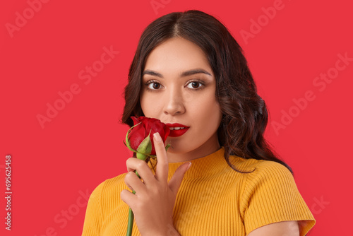 Young woman with red rose a...