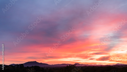 Amazing pink sunset in Arcangues with the Pyrenees and the Rhune Mountain. Basque Country of France. © LabbePhotography