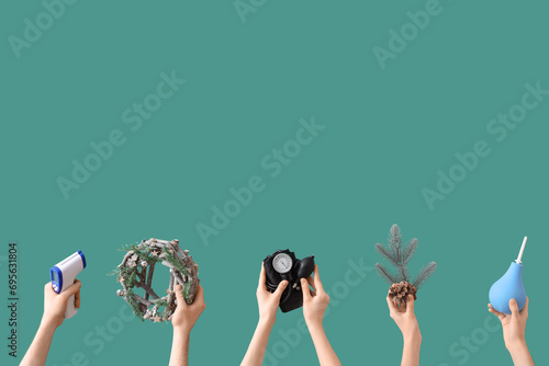 Hands holding medical equipment and Christmas decorations on green background