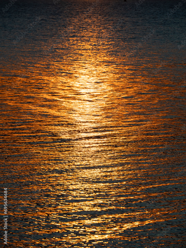 golden hour, golden track of sunlight along the sea water
