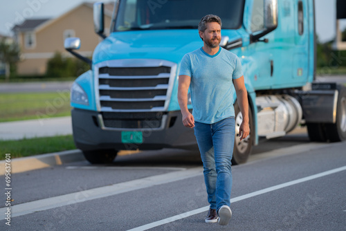 Men driver near lorry truck. Truck driver. Trucking owner. Transportation vehicles. Handsome man posing in front of truck. Semi trucks vehicle.