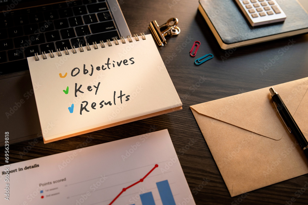 There is notebook with the word Objectives Key Results. It is as an eye-catching image. There is notebook with the word Objectives Key Results. It is as an eye-catching image.