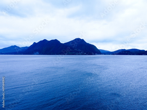  hills and pale blue mountains on the horizon, clear sky. Background. Italy