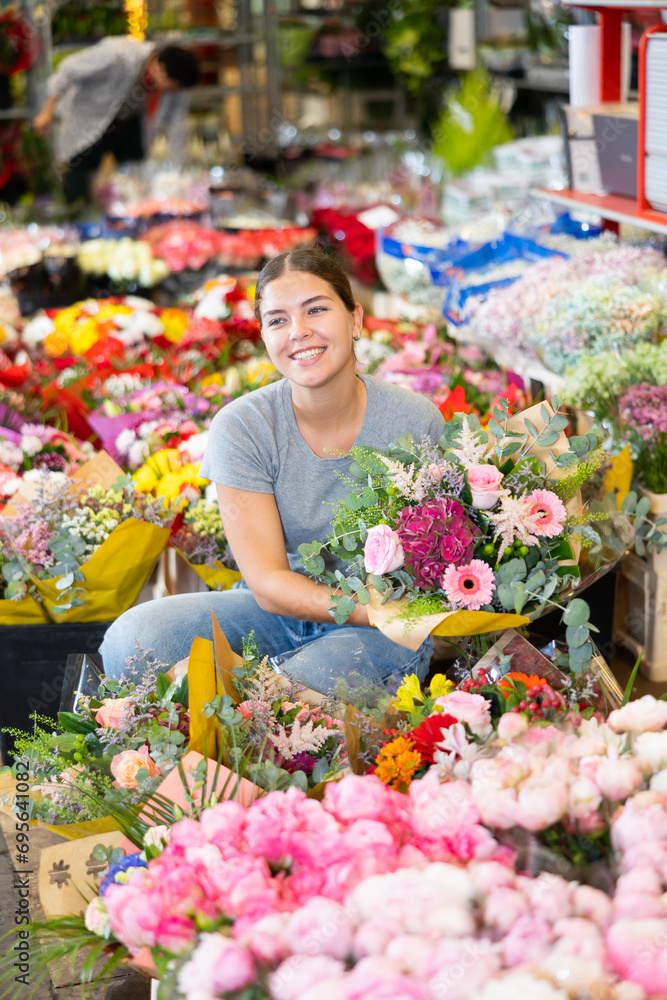 Female shopper chooses a chic bouquet of flowers at the flower market