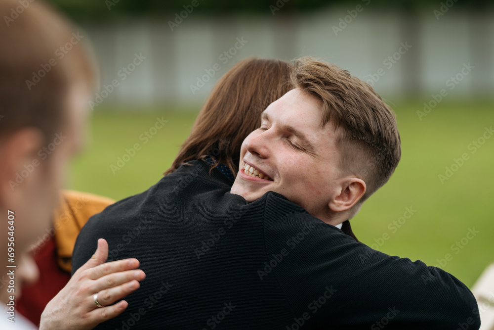 A friend hugs the groom, congratulating him on his wedding day. A friend hugs the groom, congratulating him on his wedding day.