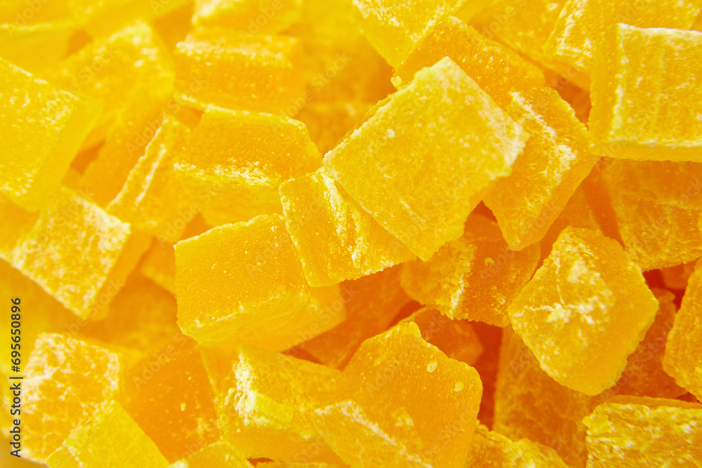 Diced mango dried fruits texture background, top view. Dehydrated mango chips dices, sweet food closeup. The sweet aroma of dehydrated mango cubes is irresistible Diced mango dried fruits texture background, top view. Dehydrated mango chips dices, sweet food closeup. The sweet aroma of dehydrated mango cubes is irresistible