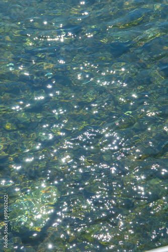 sun shining on the blue-green waves