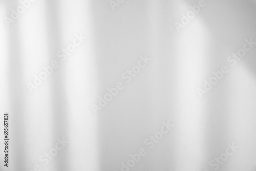 Shadow from window and curtains on white wall indoors photo