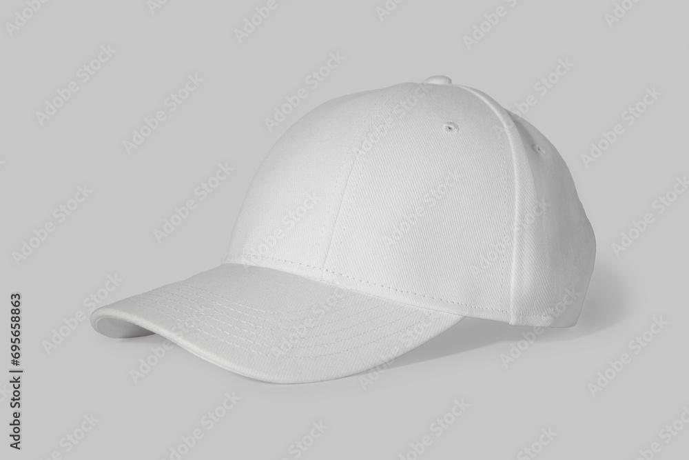 Stylish white baseball cap on light background Stylish white baseball cap on light background