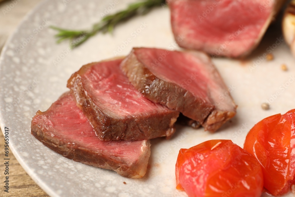Delicious grilled beef steak with tomatoes on plate, closeup