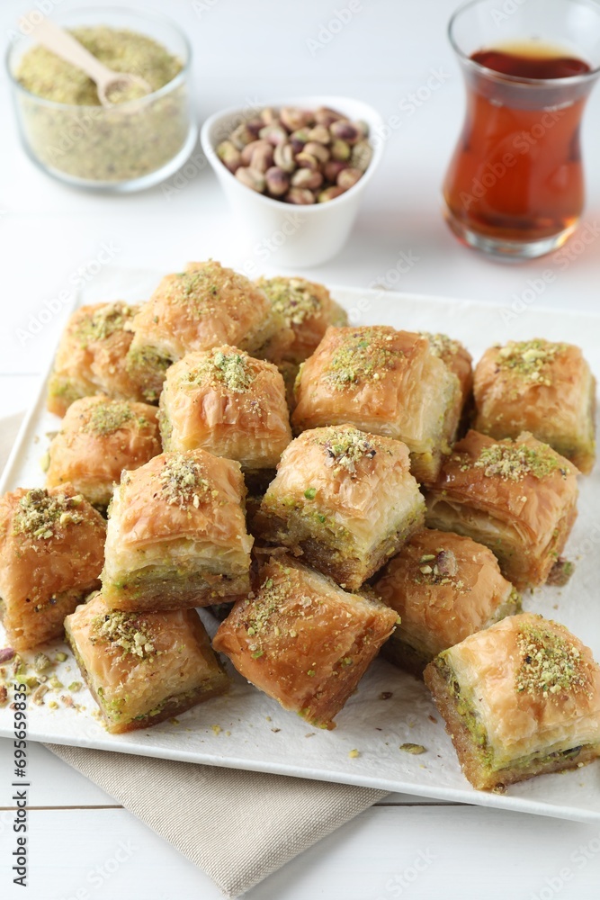 Delicious fresh baklava with chopped nuts served on white table. Eastern sweets Delicious fresh baklava with chopped nuts served on white table. Eastern sweets