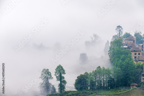 The cottage in the morning fog of Ailao Mountain, Yuanyang County, Honghe Prefecture, Yunnan Province, China. photo