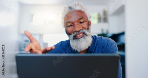 Senior, black man and video call on laptop in home for voip communication, social networking and chat. Elderly guy speaking on computer for virtual conversation, online contact and digital connection photo