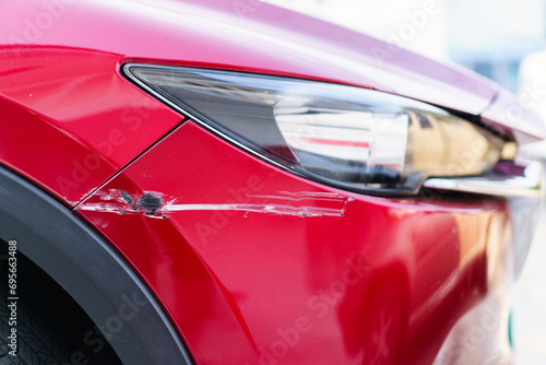 Fotografie Close up shot at front bumper of vehicle got hit or crack from road accident