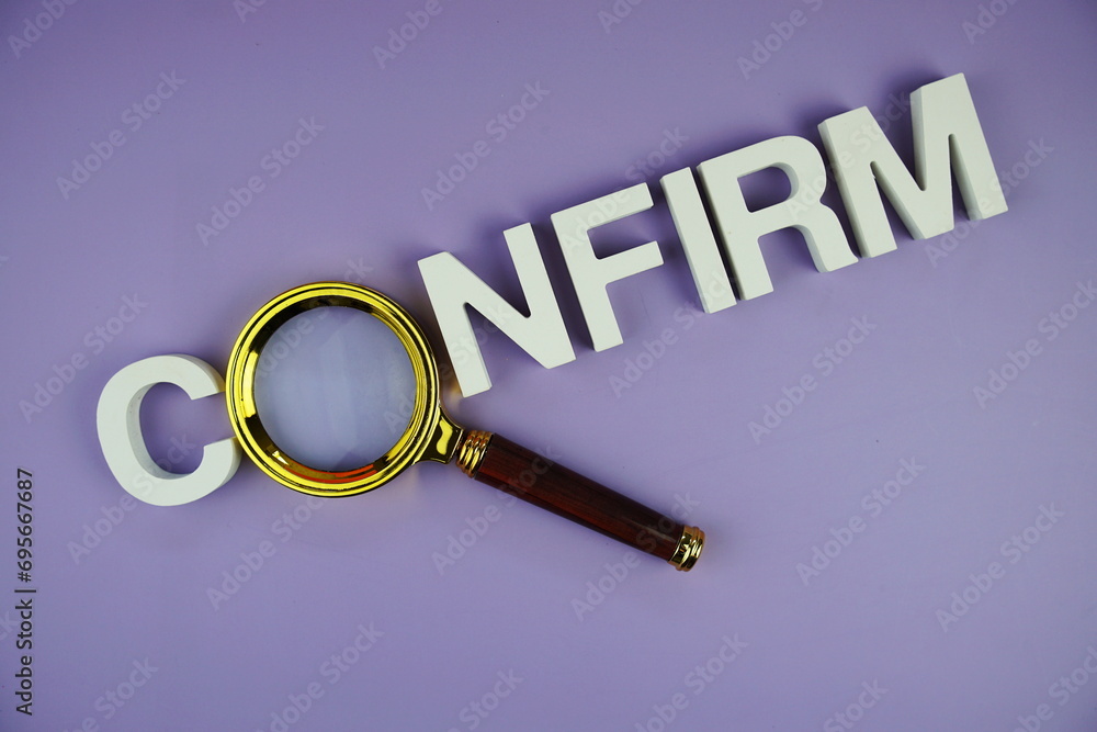 Confirm alphabet letters with magnifying glass, business and education concept background Confirm alphabet letters with magnifying glass, business and education concept background