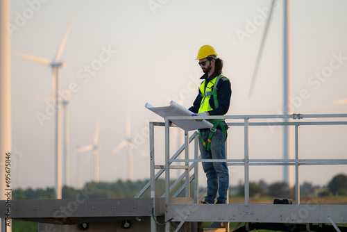 Engineer at natural energy wind turbine site with a mission to climb up to the wind turbine blades to inspect the operation of large wind turbines