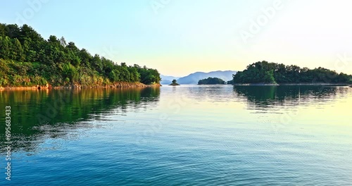 Clear lake and green forest with mountain in the summer, Hangzhou, China. Beautiful Xin 'anjiang reservoir natural landscape.