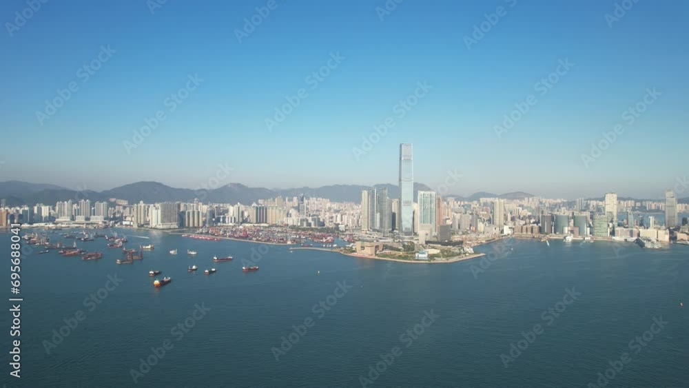 West Kowloon Cultural District, A grass field Waterfront Promenade with the cityscape of high rise buildings near Central, Victoria Harbour, Hong Kong in the background, Aerial view West Kowloon Cultural District, A grass field Waterfront Promenade with the cityscape of high rise buildings near Central, Victoria Harbour, Hong Kong in the background, Aerial view