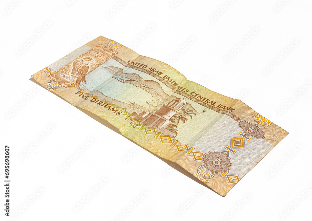 One banknote of the National Bank of the United Arab Emirates in denominations of five dirhams on a white background One banknote of the National Bank of the United Arab Emirates in denominations of five dirhams on a white background