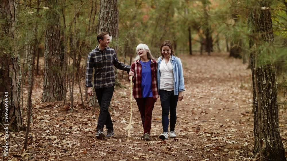 Family With Elderly Mother Walking Along Mountain Trail Family With Elderly Mother Walking Along Mountain Trail