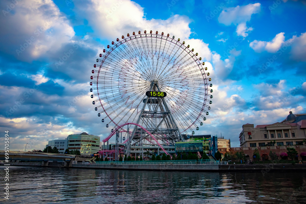 A ferris wheel at the urban city in Yokohama wide shot