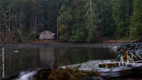 Photography A Serene and Natural Landscape Scene with a lakeside cabin