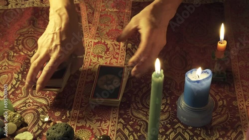 Close-up of tarot deck being shuffled and cut before reading the client's future in an real consultation of a mystic and exoteric fortune teller. photo
