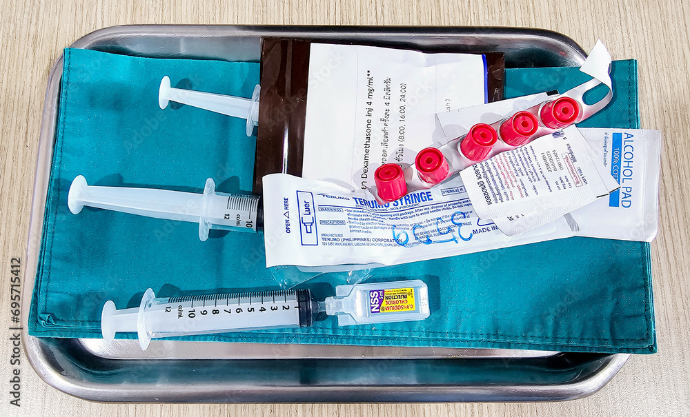 Medical equipment. Medicine, Syringes of Normal saline solution (NSS), Alcohol pad, next to