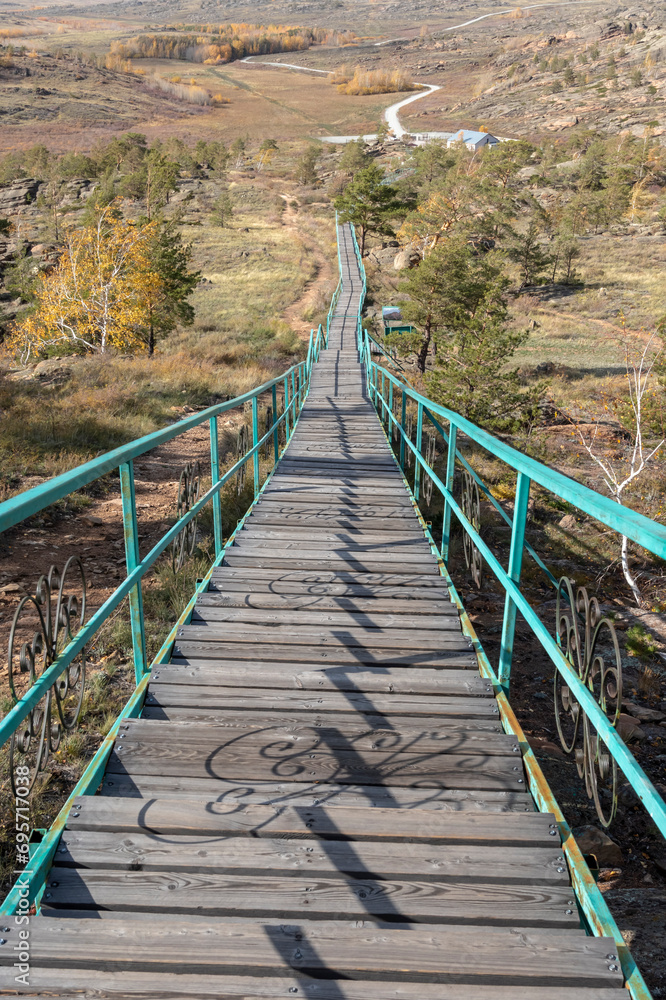 Obraz premium a very long road to the top of the mountain of the Bayanaul Nature Reserve in autumn
