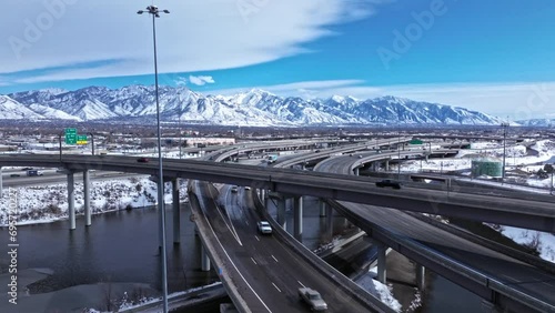 Drone view of traffic on spaghetti bowl in Salt Lake City, snowy mountains photo