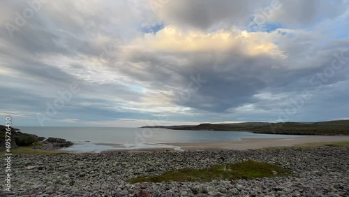 A calm and cloudy summer evening on the shores of the Barents Sea in the Varanger Peninsula, Northern Norway photo