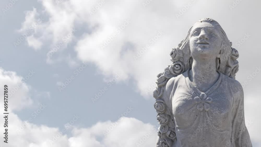 Animation of gray sculpture of woman over blue sky and clouds, copy space Animation of gray sculpture of woman over blue sky and clouds, copy space