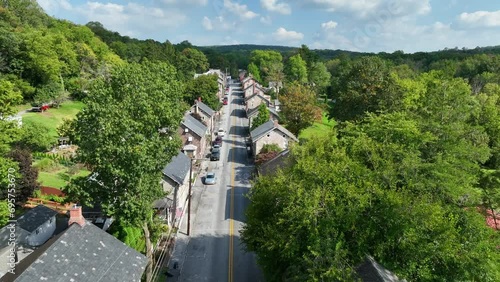 Narrow street with stone houses and green trees in summer. Aerial view of Miners Village in USA. photo