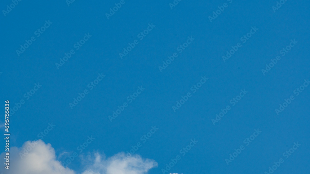 Blue sky background with tiny clouds and space for text. Blue sky background with tiny clouds and space for text.