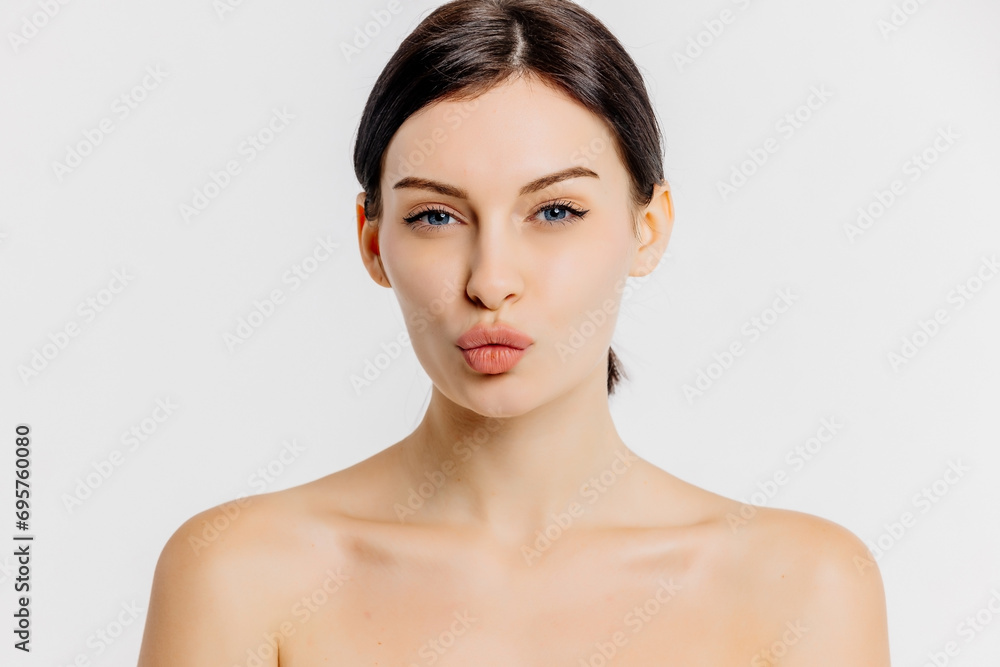 Beautiful woman face with blue eyes looking at camera, isolated on white studio background. Skin care treatment or cosmetic ads concept.Female model with perfect fresh and clean skin Beautiful woman face with blue eyes looking at camera, isolated on white studio background. Skin care treatment or cosmetic ads concept.Female model with perfect fresh and clean skin