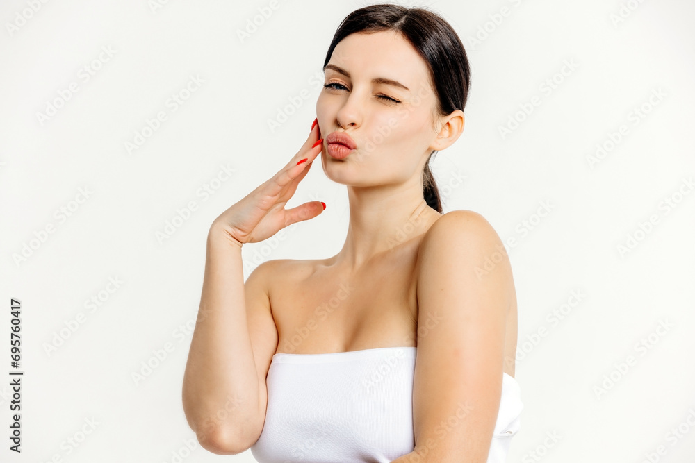 Beautiful woman face with blue eyes looking at camera, isolated on white studio background. Skin care treatment or cosmetic ads concept.Female model with perfect fresh and clean skin Beautiful woman face with blue eyes looking at camera, isolated on white studio background. Skin care treatment or cosmetic ads concept.Female model with perfect fresh and clean skin