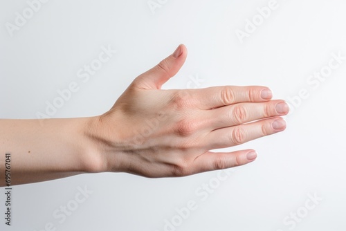 A person holding their hand out in front of a white wall. Versatile image suitable for various concepts