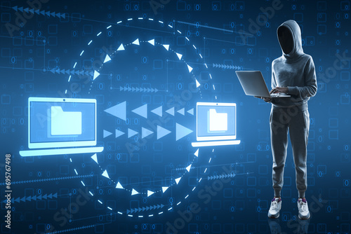  Hacker using laptop with creative digital data transfer and exchange folders on blue backdrop. Backup data, virtual document storage or loading on cloud service.