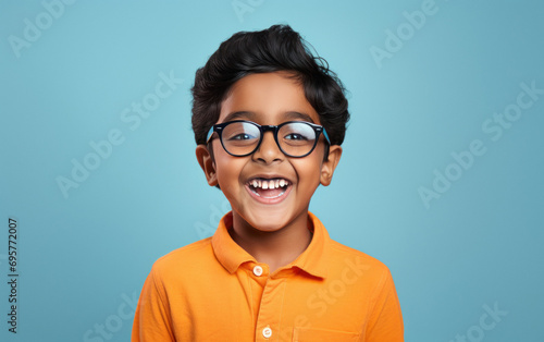 cute little boy wearing eyeglasses and giving shocking expression photo