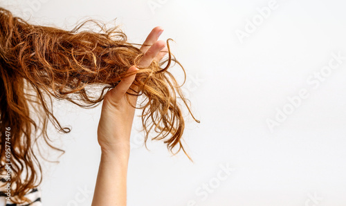 Φωτογραφία Hair problems. Female person showing her damaged and dry hair.
