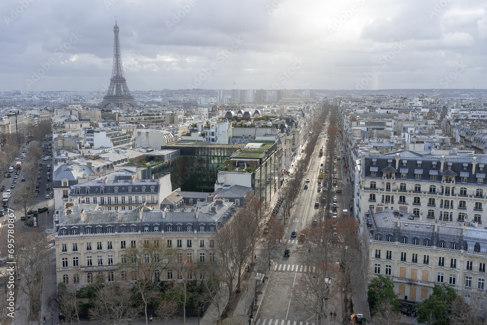 Paris, France - January 14th 2019 : View of Paris from the triumphal arch with two avenues and the Eiffel tower in the background. Paris, France - January 14th 2019 : View of Paris from the triumphal arch with two avenues and the Eiffel tower in the background.