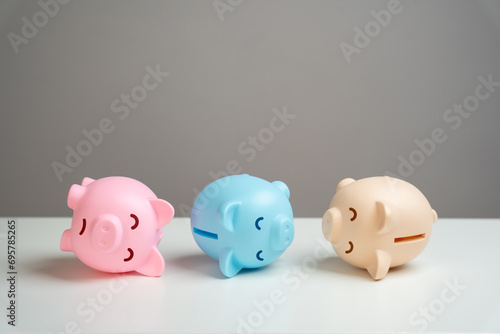 The piggy banks lie in agony. Financial crisis, end of savings, bankruptcy. Refinancing restructuring of debts. Economic depression. Depletion of savings and financial resources. Exorbitant expenses. photo