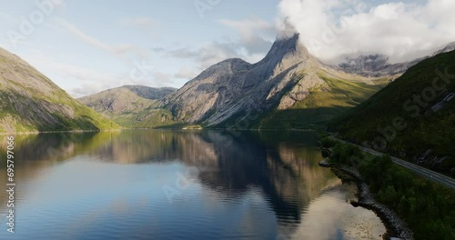 Scenic arctic road next to Tysfjord with Stetind mountain reflection, aerial photo