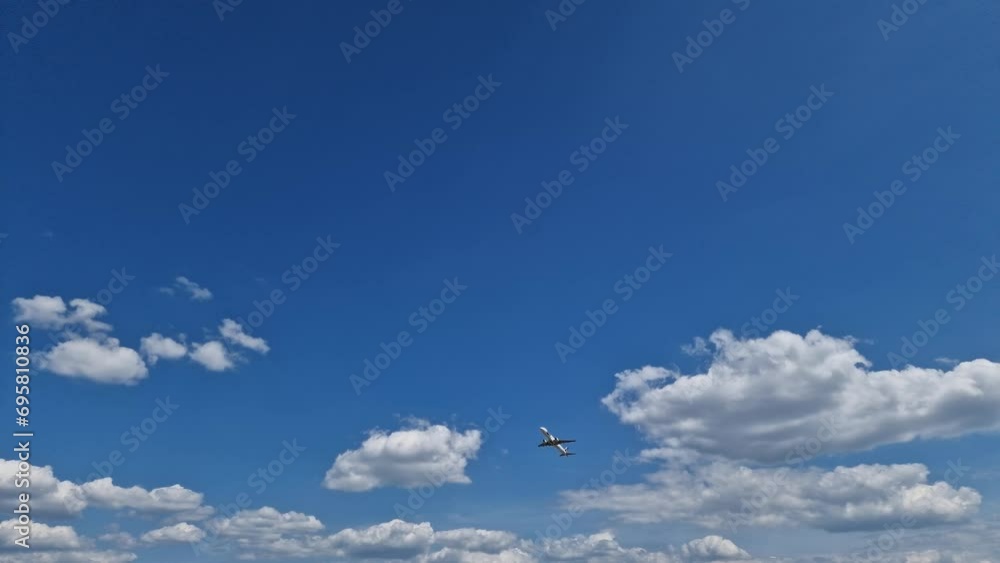 Airplane LOT taking off at against a blue sky with white clouds Airplane LOT taking off at against a blue sky with white clouds
