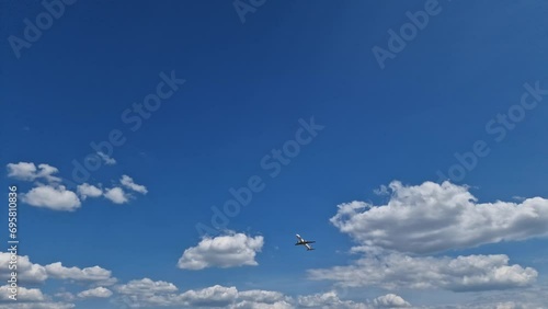 Airplane LOT taking off at against a blue sky with white clouds