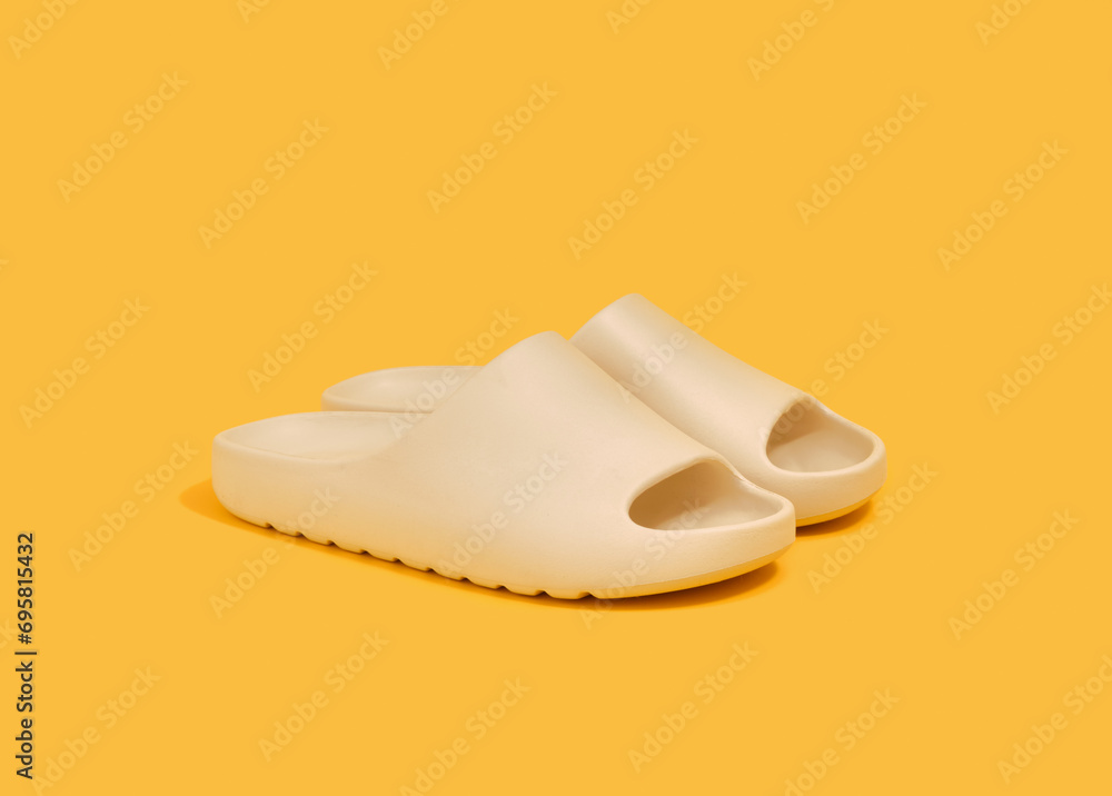 Summer flip flops on a yellow background. Comfortable stylish shoes for men and women. Summer flip flops on a yellow background. Comfortable stylish shoes for men and women.